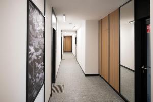 a hallway with black and white walls and a door at APARTAMENT BOHO in Gdańsk