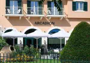 un hotel con ombrelloni di fronte a un edificio di Arcadion Hotel a Città di Corfù