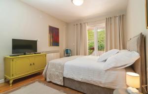 a bedroom with a large bed and a television at House with pool Garden in Žrnovnica +51 photos