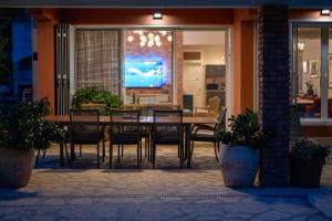 a dining room with a table and chairs at House with pool Garden in Žrnovnica
