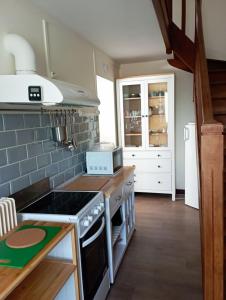 a kitchen with a stove top oven next to a counter at gite du puits in Bernières-dʼAilly