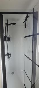 a glass door with a pair of scissors on it at Chalet Sea-renity Lakeside met jacuzzi in Jabbeke +56 photos