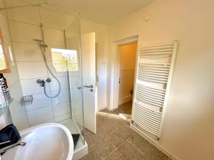 a bathroom with a sink and a glass shower at Akram Appartement IV - Nähe Bahnhof in Hildesheim