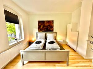 a bedroom with a bed with two pillows on it at Akram Appartement IV - Nähe Bahnhof in Hildesheim
