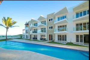 a house with a swimming pool in front of it at Cristamar Condominium "Cozy Oasis, Adorable" in Cabarete