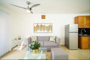 a living room with a couch and a refrigerator at Cristamar Condominium "Cozy Oasis, Adorable" in Cabarete