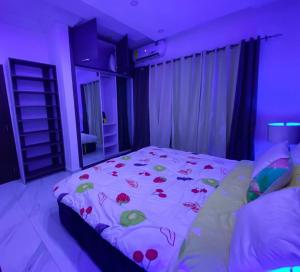 a bedroom with a large bed with flowers on it at IRISH Apartment in Kasoa
