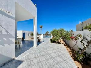 a courtyard of a house with white walls at Villa Yasmine in Djerba