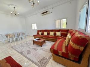 a living room with a couch and a table at Villa Yasmine in Djerba