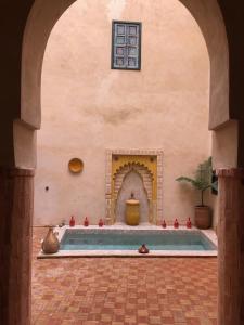 an archway with a swimming pool in a building at Riad Paquerette in Marrakesh