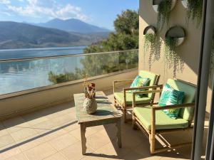 two chairs and a table on a balcony with a view at Beach House in Itea-Delphi in Itea