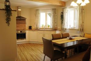 a kitchen and dining room with a table and chairs at das stille Paradies in Ledenitzen