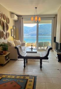 a living room with a table and a large window at Beach House in Itea-Delphi in Itea