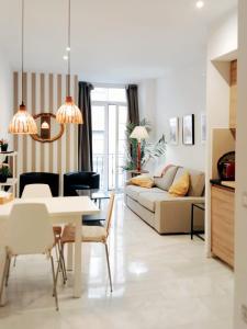 uma sala de estar com uma mesa e um sofá em Viktory Apartments em Valladolid