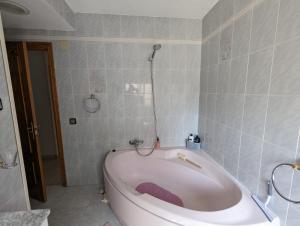 a bath tub in a bathroom with a shower at Casa Plaza Relleu in Relleu