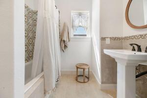 a white bathroom with a sink and a tub and a sink at High Hopes on the bay! in San Leon +22 photos