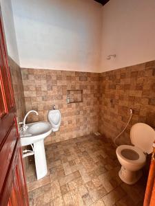 a bathroom with a toilet and a sink at Brisa do Sol in Cascavel