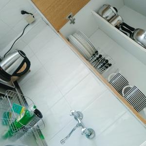 a kitchen counter with a dish drying rack and a sink at Frini Apartments and Studios in Paralia Katerinis