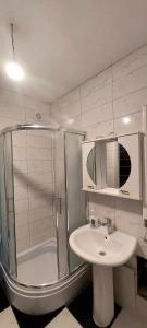 a bathroom with a shower and a sink at ARIA in Mitrovica