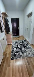 a room with a door and a rug on the floor at ARIA in Mitrovica