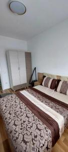 a bedroom with a large bed in a room at ARIA in Mitrovica