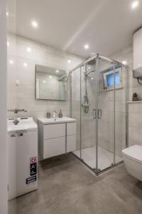 a bathroom with a shower and a sink and a toilet at Luxury Apartment Anna in Split