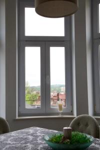 a dining room with a table and a window at Apartament Ratuszowy in Cieszyn