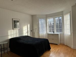 a bedroom with a bed and two windows at Marley's home in Woodlawn