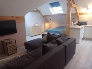 a living room with a couch and a bedroom at Appartement Les Ondines 4 pers. in Lemberg