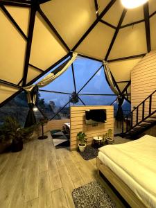 a room with a tent with a bed and a tv at The Soul Stroll Cottages Retreat in Mukteswar