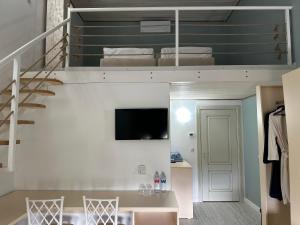 a living room with a loft bed and a staircase at Pensiunea Ancuței in Şerpeni
