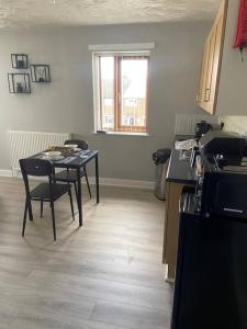 a kitchen with a table and chairs in a room at Olympic Place 1-bed Apartment in Rowley Regis