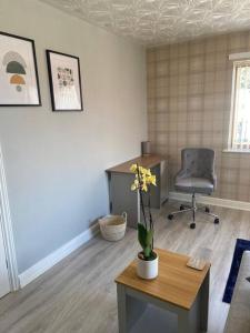 an office with a desk and a chair and a table at Olympic Place 1-bed Apartment in Rowley Regis