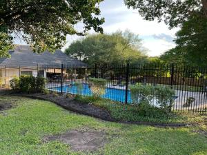 a fence around a swimming pool in a yard at Texas Luxury Home 2 in San Antonio