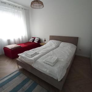 a bedroom with a bed with two towels on it at Apartament Czartoryskich House z miejscem postojowym in Puławy