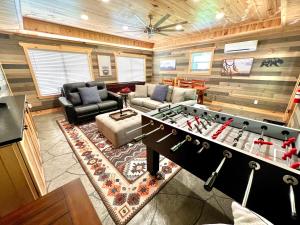 a living room with a foosball table in the center at Catons Chapel cabin in Sevierville