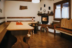 a living room with a table and a fireplace at Rustic Wood Villa in Liban