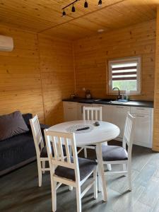 a kitchen and dining room with a table and chairs at Stajnia Bocianie Gniazdo in Uniejow