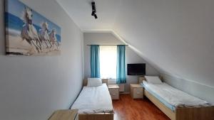 a small room with two beds and a window at Magnum Nadole in Nadole