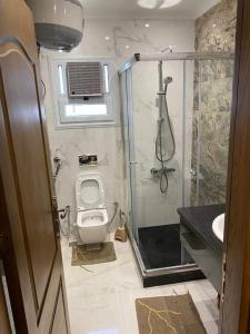 a bathroom with a shower and a toilet and a sink at Jordan family in Amman