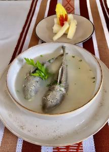 two pieces of fish in a bowl on a table at Hostal Gocta in Cocachimba +42 photos