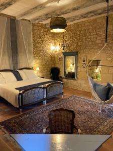 a bedroom with a bed and a hammock in a room at Château de Monsac in Monsac +31 photos