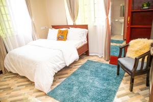 Llit o llits en una habitació de Villa Home Apartment Dodoma