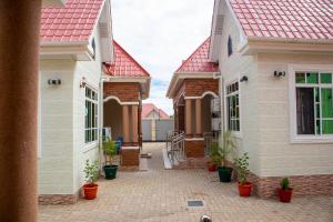 a row of houses with red roofs and potted plants at Villa Home Apartment Dodoma in Dodoma
