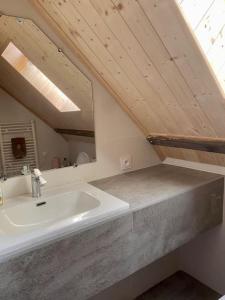 a bathroom with a sink and a mirror at Chalet Savoyard vue panoramique in Jarrier