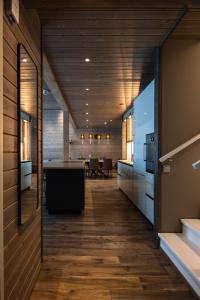 an open hallway with a kitchen and a dining room at Kultakero Northern Sky in Pyhätunturi