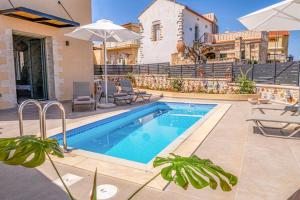 a villa with a swimming pool and a house at Kefalas Luxury Villas Patitiri with Private Pool in Epáno Kefalás