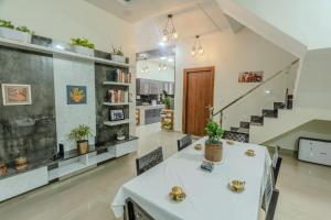 德拉敦Dhruva - Luxury Villa in CBD的一间带桌椅和楼梯的客厅
