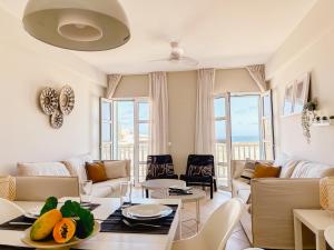 a living room with a couch and a table at Papaya Apartments Boa Vista in Sal Rei
