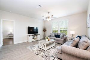 a living room with two couches and a flat screen tv at Texas Luxury Home 3 in San Antonio